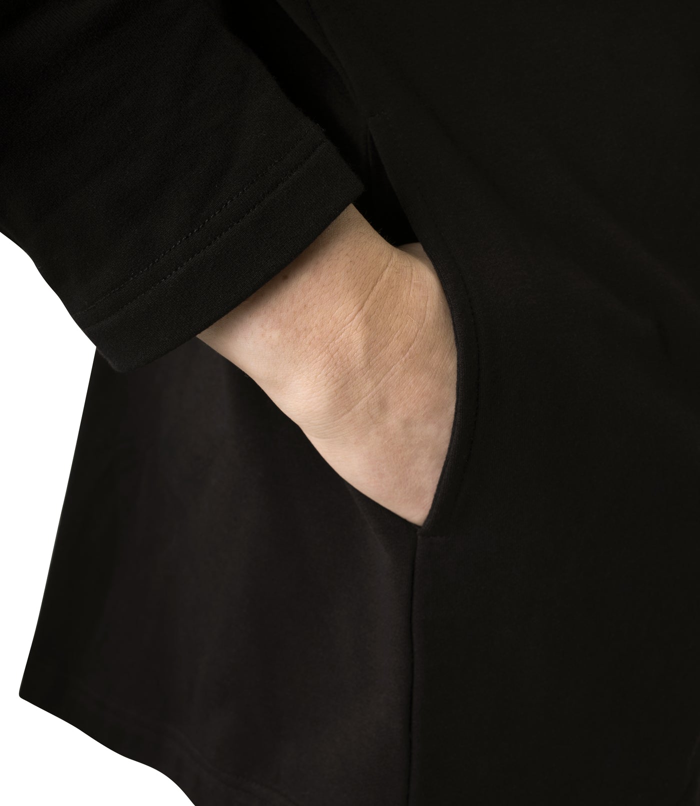 Plus-size model, facing backward, wearing JunoActive's Mavie Cotton Wrap Jacket in color black. Close up of hand in pocket.