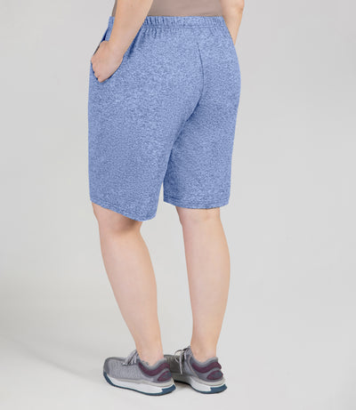JunoActive Model, facing back, wearing 149216-SoftWik Relaxed Fit Shorts with her hand in her pockets in color heather royal.