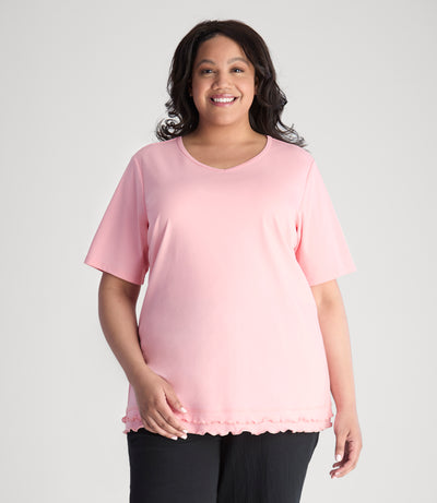 Model, wearing Cotton Chic Lettuce Trim Short Sleeve plus size Top in color peach blossom.