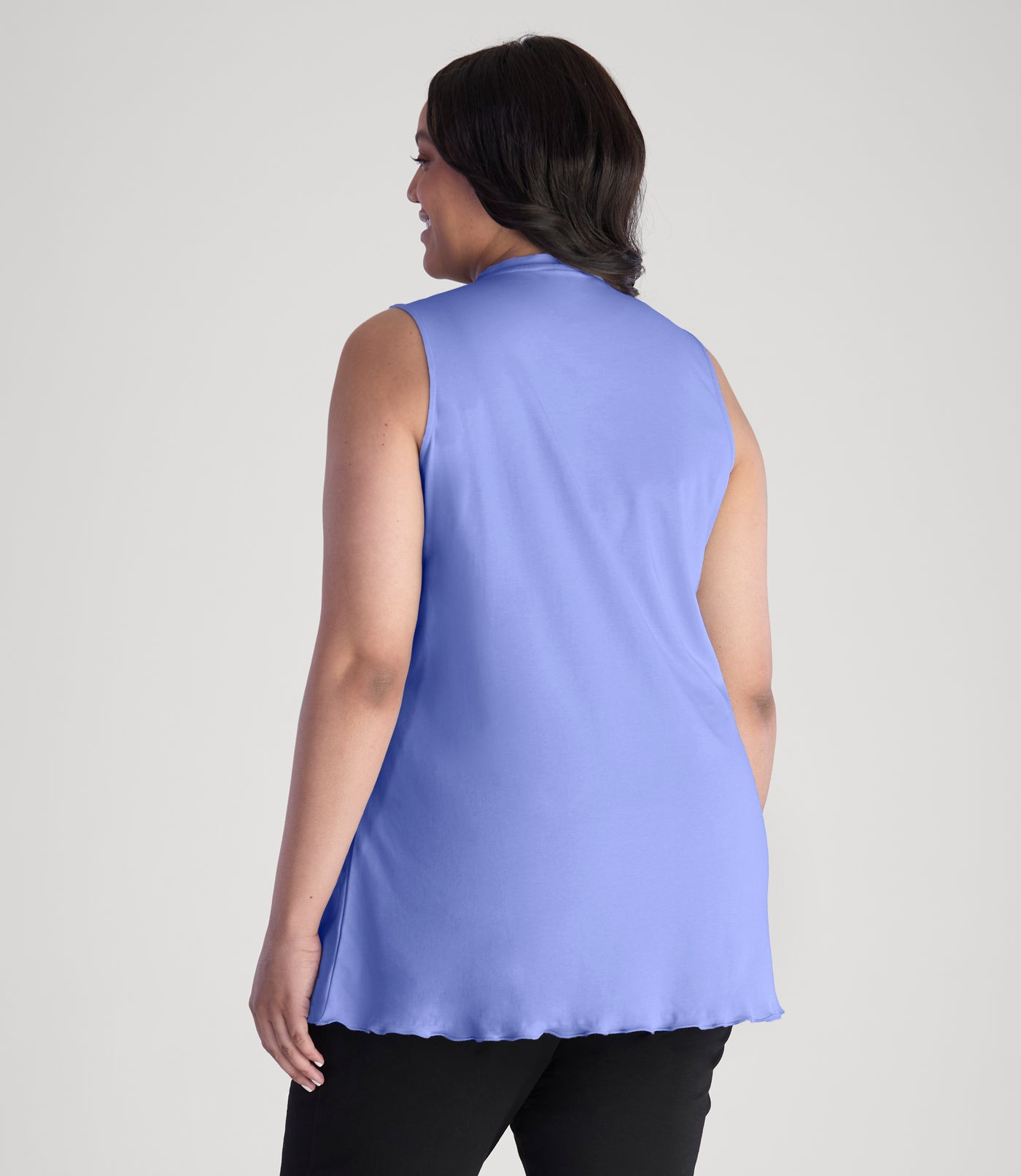 Model, facing back, wearing JunoActive's Cotton Chic Let's Trim Sleeveless plus size top in color periwinkle.