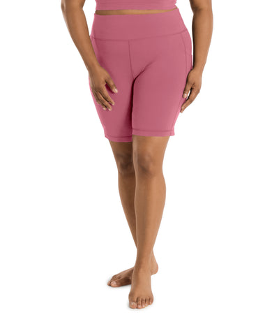 Plus size woman, front view with hands by side, wearing JunoActive JunoStretch Side Pocket Short in warm mauve. The hem is a few inches above the knee.