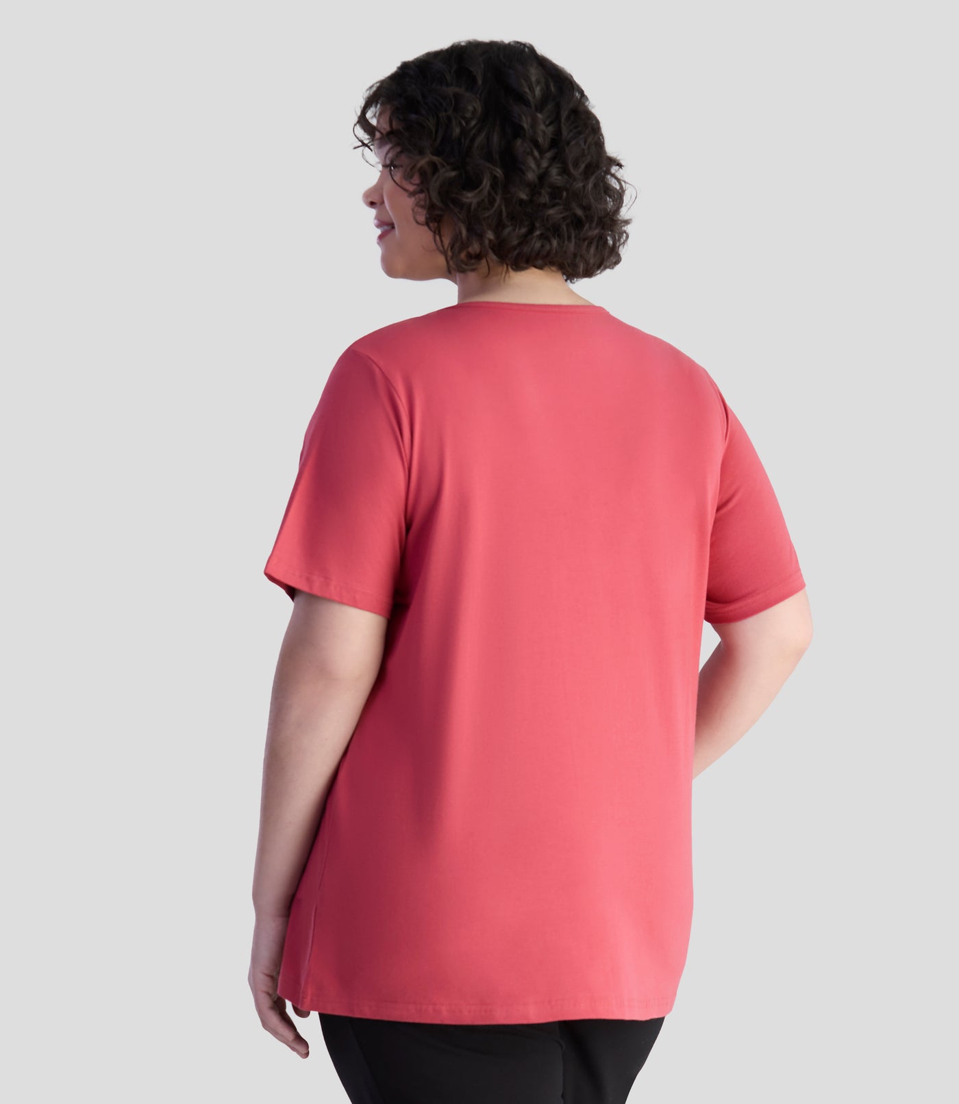 Back of model is wearing JunoActive's designer graphic v-neck top in rosy red.
