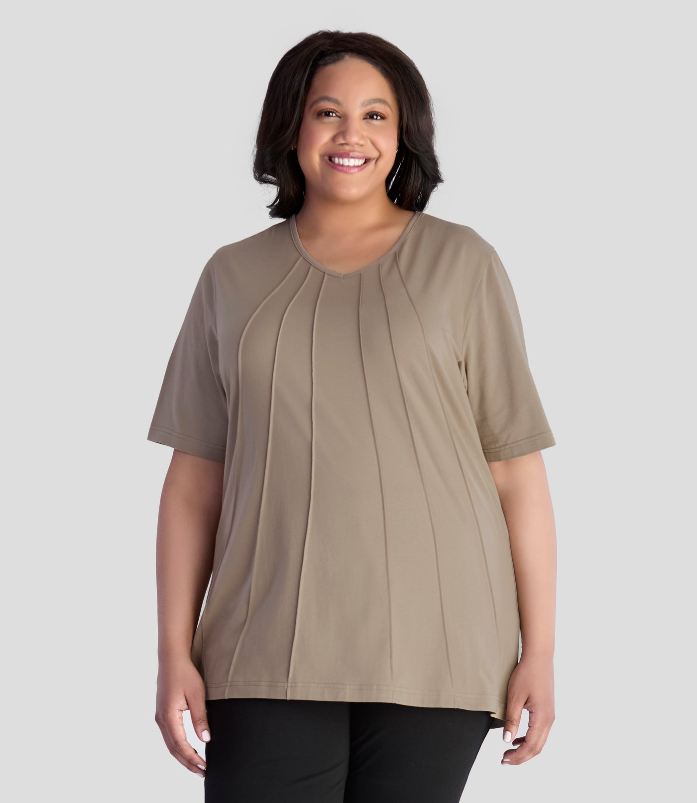 JunoActive model, wearing Stretch Naturals Lite Pintuck Top in color Beachwood. Model is facing front and hands down by her side.