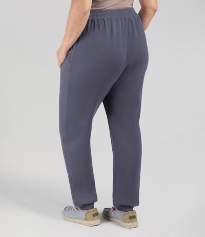 Plus size model, facing back, wearing JunoActive's Legacy Cotton Casual Pocketed Jogger in color Misty Grey. 