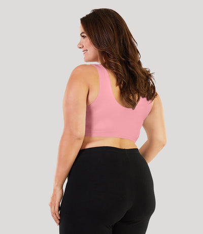 Plus size model, facing back, wearing stretch naturals Scoop Neck bra in color peach fizz.