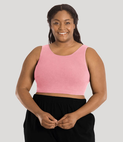 Plus size model, facing front, wearing stretch naturals full fit scoop neck bra in color peach fizz.