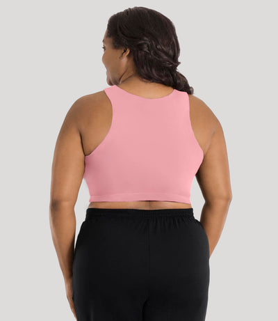 Plus size model, facing back, wearing stretch naturals full fit V-neck bra in color peach fizz.