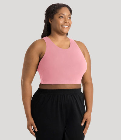 Plus size model, facing front, wearing stretch naturals full fit V-neck plus size bra in color peach fizz.