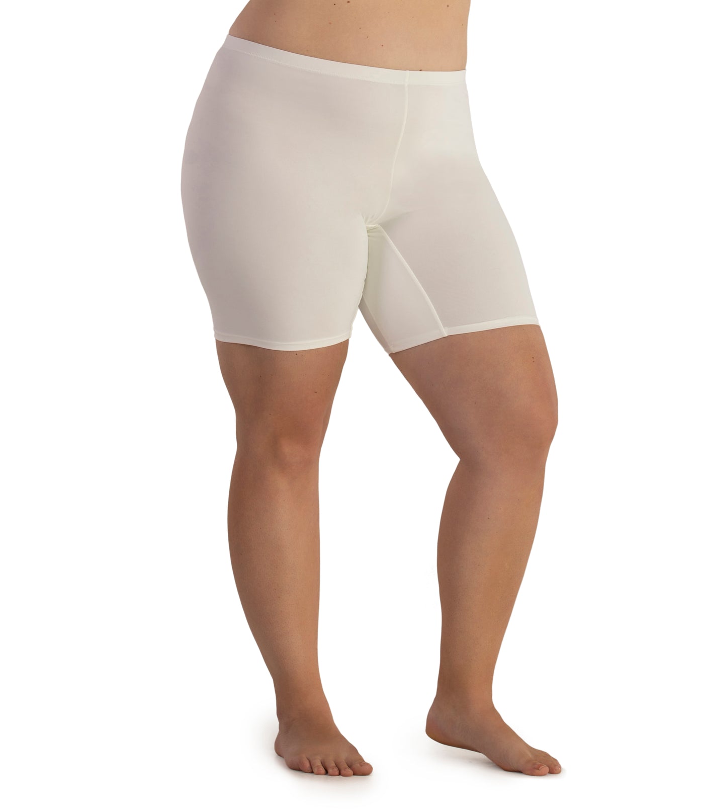 Bottom half of plus sized woman, facing side front, wearing JunoActive Junowear Hush Boxer Brief in color white. This fitted boxer fits to the waistline and leg opening is a few inches above the knee.