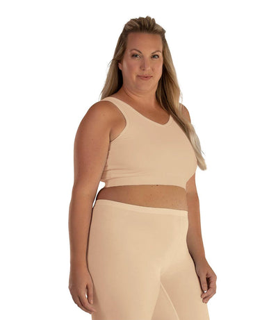 Plus size woman, facing front, wearing JunoActive plus size Junowear Hush V-Neck Bra in Ecru. The woman is wearing a ecru Junowear Hush Boxer brief. Her arms fall naturally to her side.