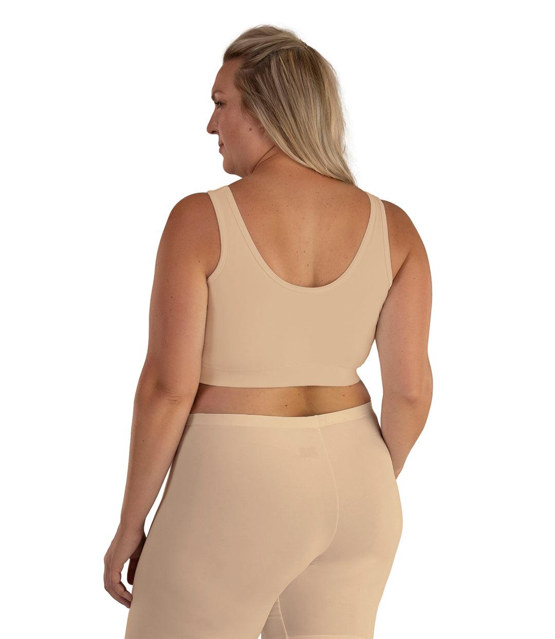Plus size woman, facing back, wearing JunoActive plus size Junowear Hush V-Neck Bra in Ecru. The woman is wearing ecru Junowear Hush Boxer brief. Her arms fall naturally to her side.