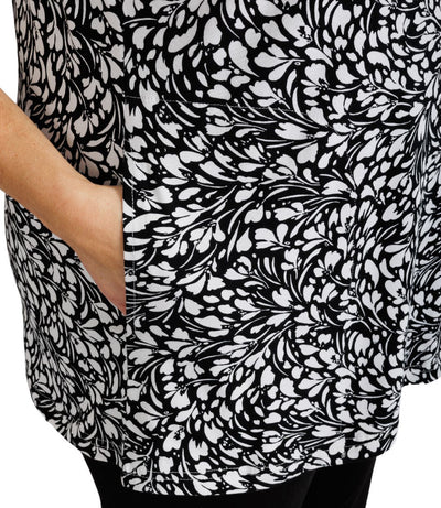 JunoActive Lifestyle Cotton three quarter sleeve pocketed tunic in print Botanic. Mannequin facing side with hand in pocket close up.