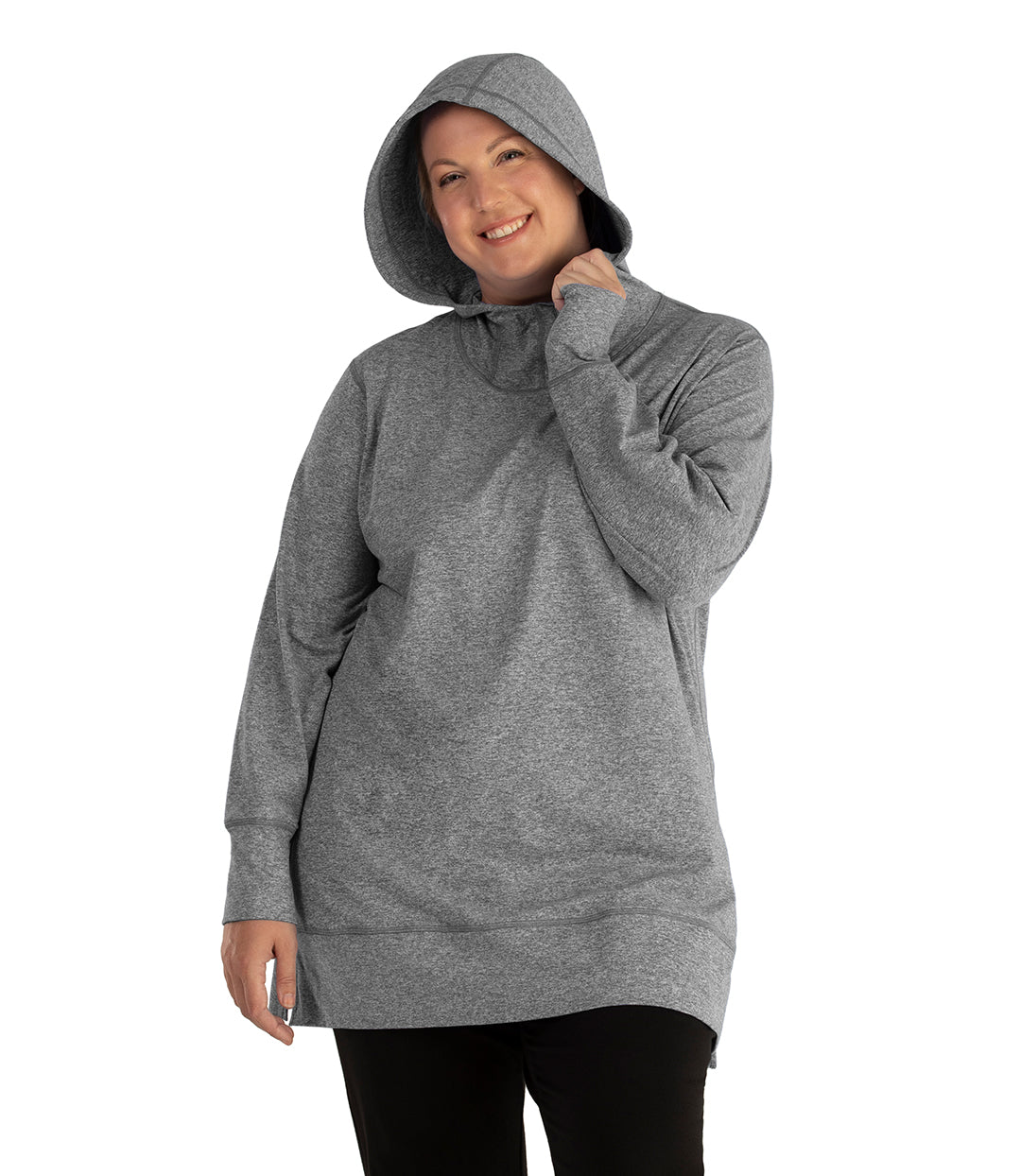 Plus size woman, facing front, wearing JunoActive plus size SoftWik Long Sleeve Hoodie in the color Heather Grey. She has the hood up on her head, covering her hair. She is wearing JunoActive Plus Size Leggings in the color Black.