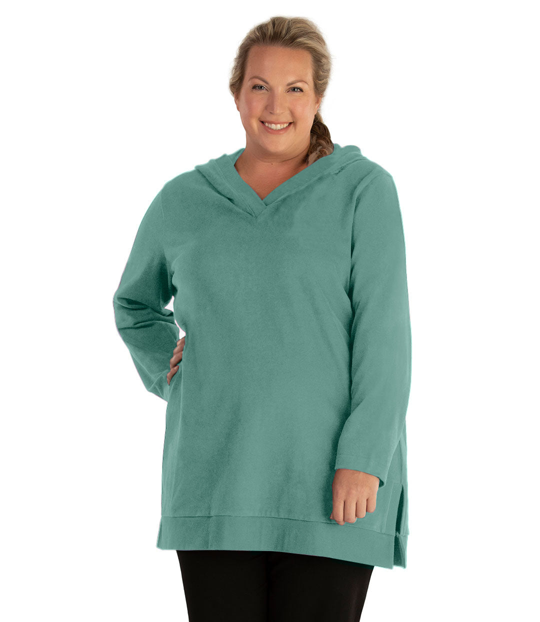 Plus size woman, facing front, wearing JunoActive plus size Legacy Cotton Casual Pullover V-Neck Hoodie in the color Lichen Green. She is wearing JunoActive Plus Size Leggings in the color Black.