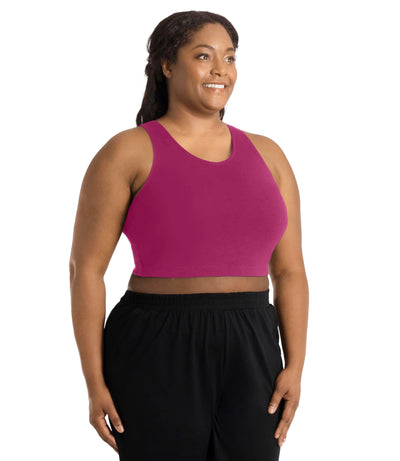 Front view of a plus size woman wearing a merlot colored JunoActive Stretch naturals full fit plus size bra. Featuring a v-neck and side bust darts for a full fit. She is also wearing black JunoActive plus size pants.