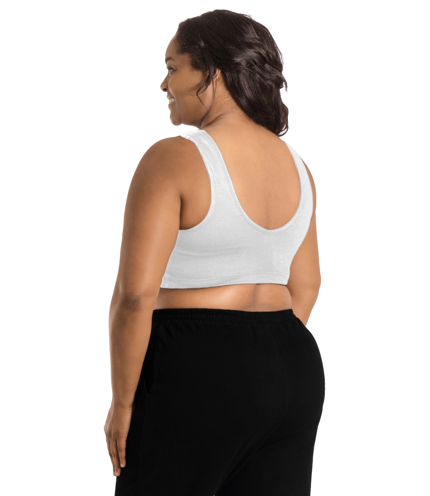 Plus size woman, facing back, wearing JunoActive Stretch Naturals Shirred Bra Top. Bra is gathered in middle on front and is a scoop top neck and scoops in back showing upper back. Straps are wide and bra color is white.