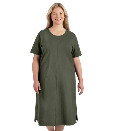 Plus size woman, facing to the front, wearing JunoActive plus size Stretch Naturals Short Sleeve Dress in the color moss green.