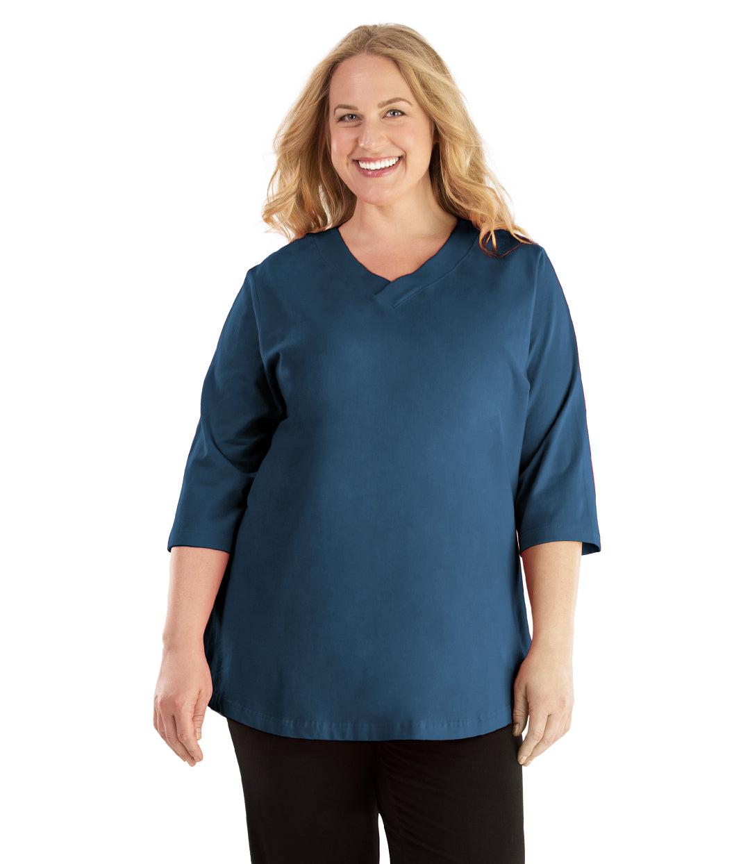 Plus size woman, facing front, wearing JunoActive plus size Stretch Naturals Vee NeckTee in the color French Blue. She is wearing JunoActive Plus Size Leggings in the color Black. 