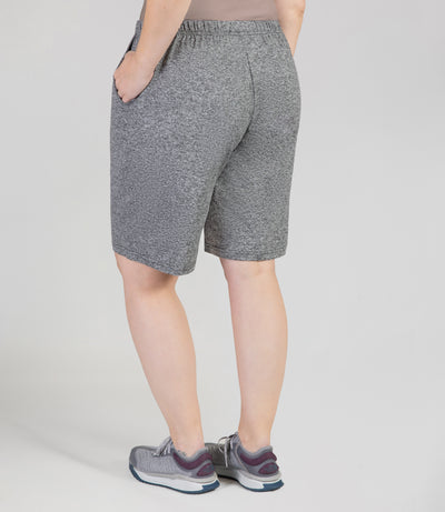 JunoActive Model, facing back, wearing 149216-SoftWik Relaxed Fit Shorts with her hand in her pockets in color heather grey.