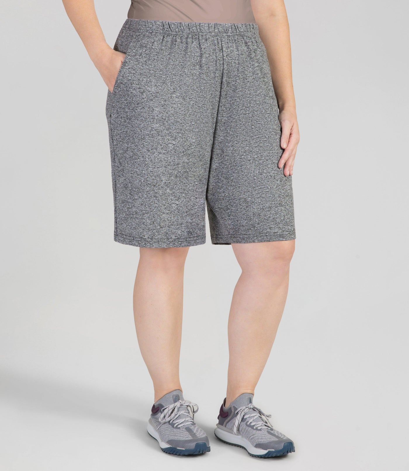 JunoActive Model, facing front, wearing 149216-SoftWik Relaxed Fit Shorts with her hand in her pockets in color heather grey.