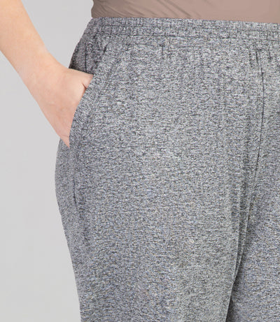 Close up, bottom half of plus sized woman, wearing JunoActives SoftWik Relaxed Fit Long Capris with Pockets in heather grey. Hemline ends at mid-calf of model.
