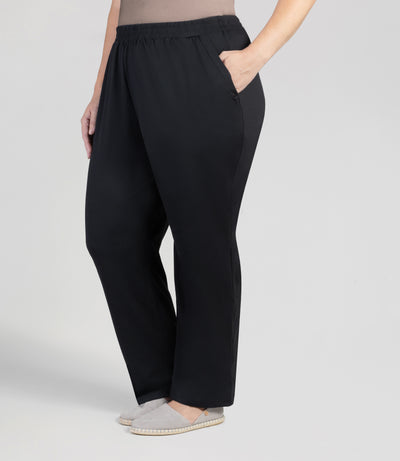 front view, bottom half of plus sized woman, wearing JunoActives Softwik Relaxed fit pocketed pant and is full length. Color is black.