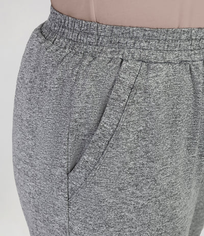 Close up, bottom half of plus sized woman, wearing JunoActives Softwik Relaxed fit pocketed pant and is full length. Color is heather gray.