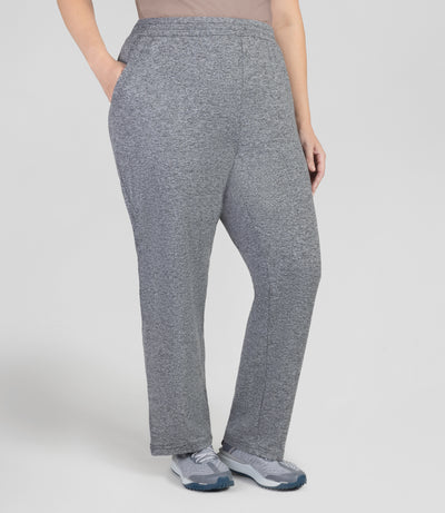 front view, bottom half of plus sized woman, wearing JunoActives Softwik Relaxed fit pocketed pant and is full length. Color is heather gray.