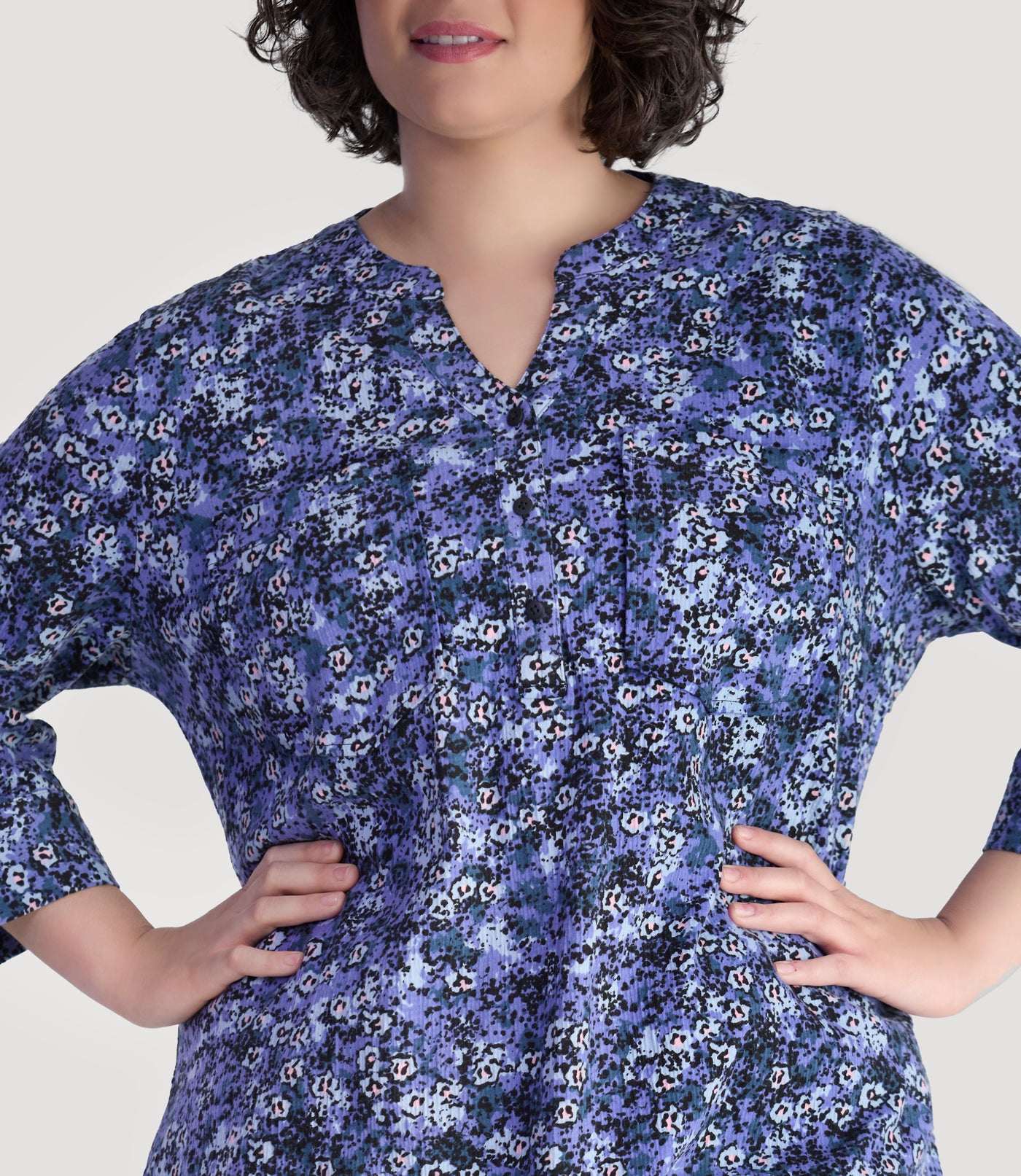 Plus size model, facing front and close up, wearing EZ Style Cotton plus size 3/4 Sleeve Split Neck Tunic with Pockets in blue meadow print.