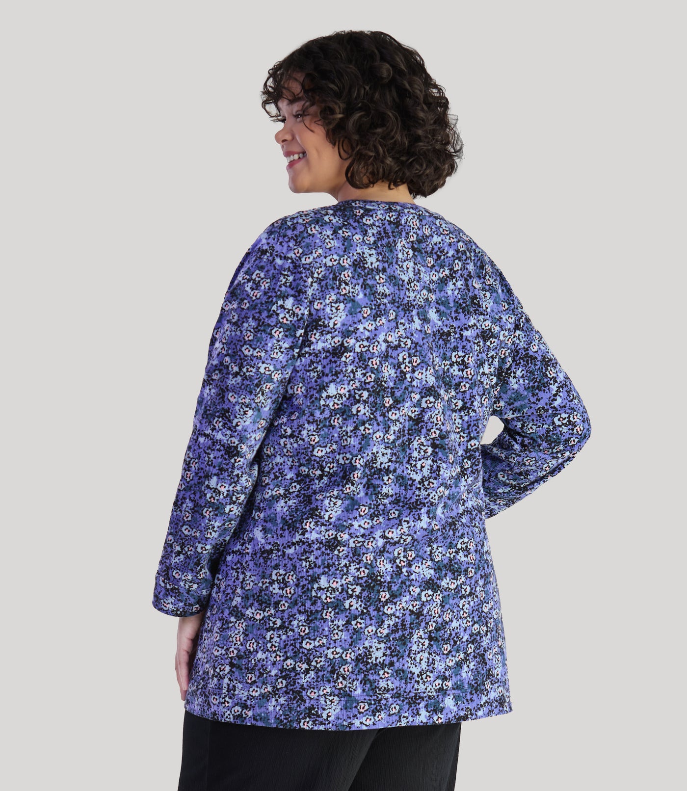 Model, facing back, wearing JunoActive's plus size EZ Style Cotton Long Sleeve Pocket plus size Jacket in color blue meadow print.