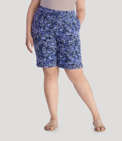 Plus size model, facing front, wearing EZ Style Cottons Pocketed plus size Short in blue meadow print.