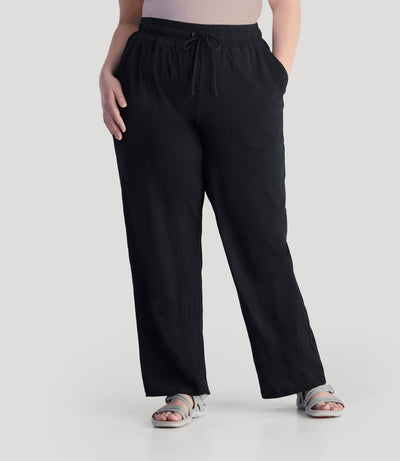 Plus size model, facing front, wearing JunoActive's EZ Style Cotton Pocketed plus size Pant in color black.