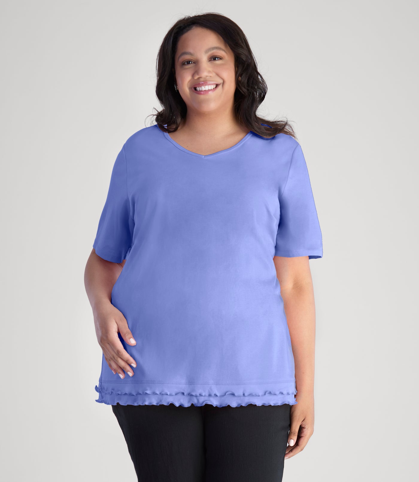 Model, wearing Cotton Chic Lettuce Trim Short Sleeve plus size Top in color periwinkle.
