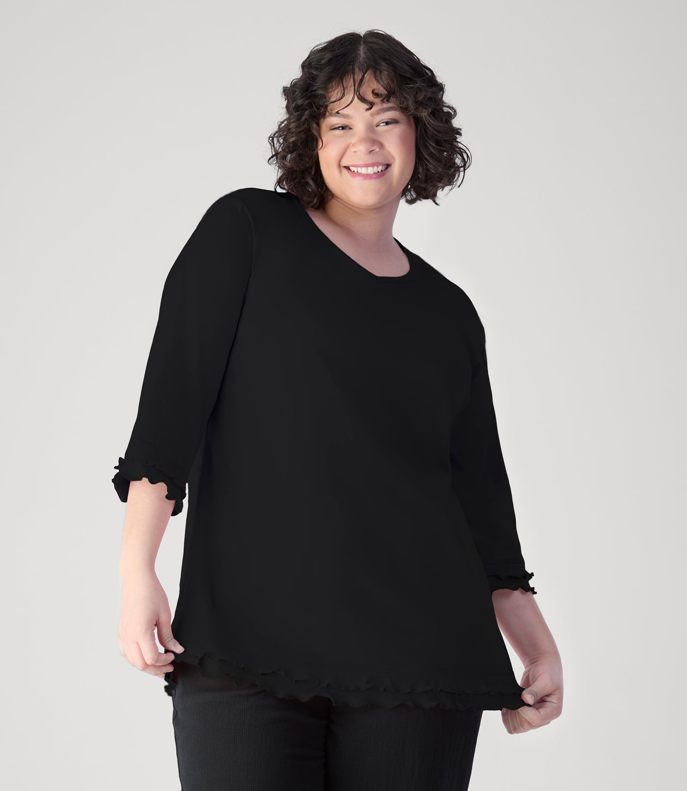 Model, facing front, wearing cotton chic lettuce trim 3-4 sleeve plus size top in color black.