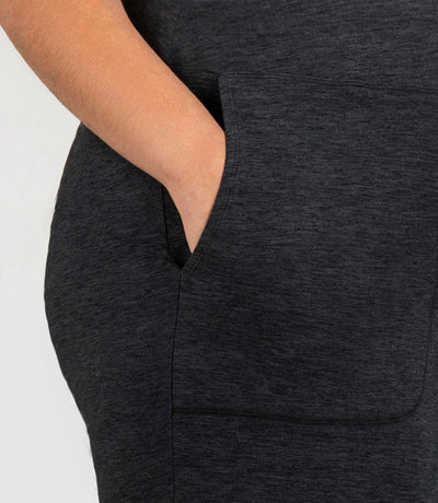 JunoActive model, close up, wearing SoftSupreme Pocketed Lounge Capri in color heather black. Right hand in pocket of capri.