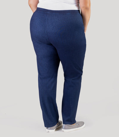 Plus size model, facing back, wearing Stretch Twill plus size pant in denim blue.