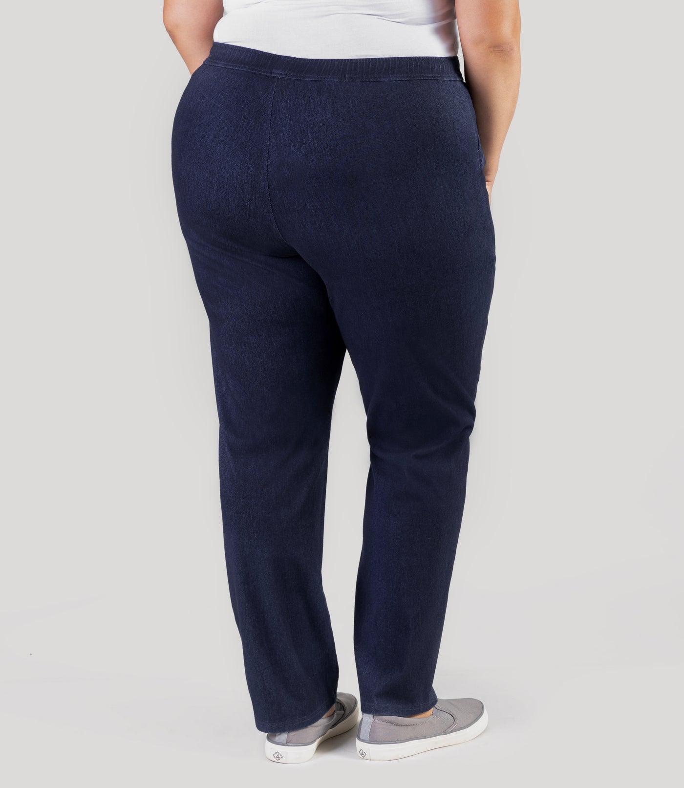 Plus size model, facing back, wearing Stretch Twill plus size pant in denim blue.