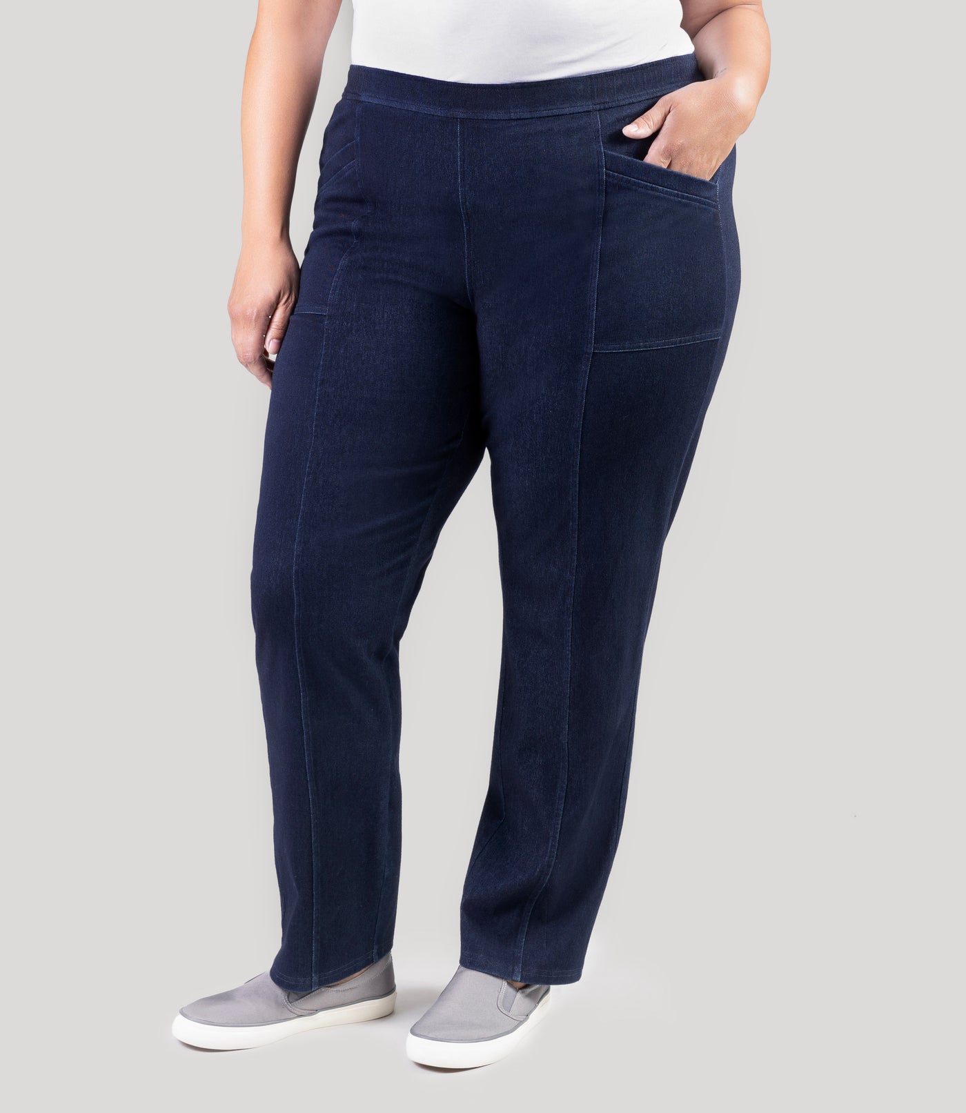 Plus size model, facing front, wearing Stretch Twill plus size pant in denim blue.