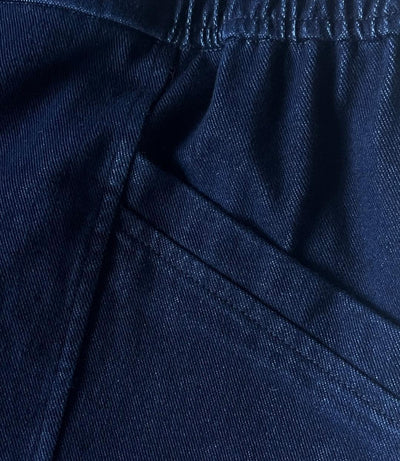 Close up of Twill pant fabric to show texture and high quality of product. Featuring part of the pocket, side banding and stitching of seams.