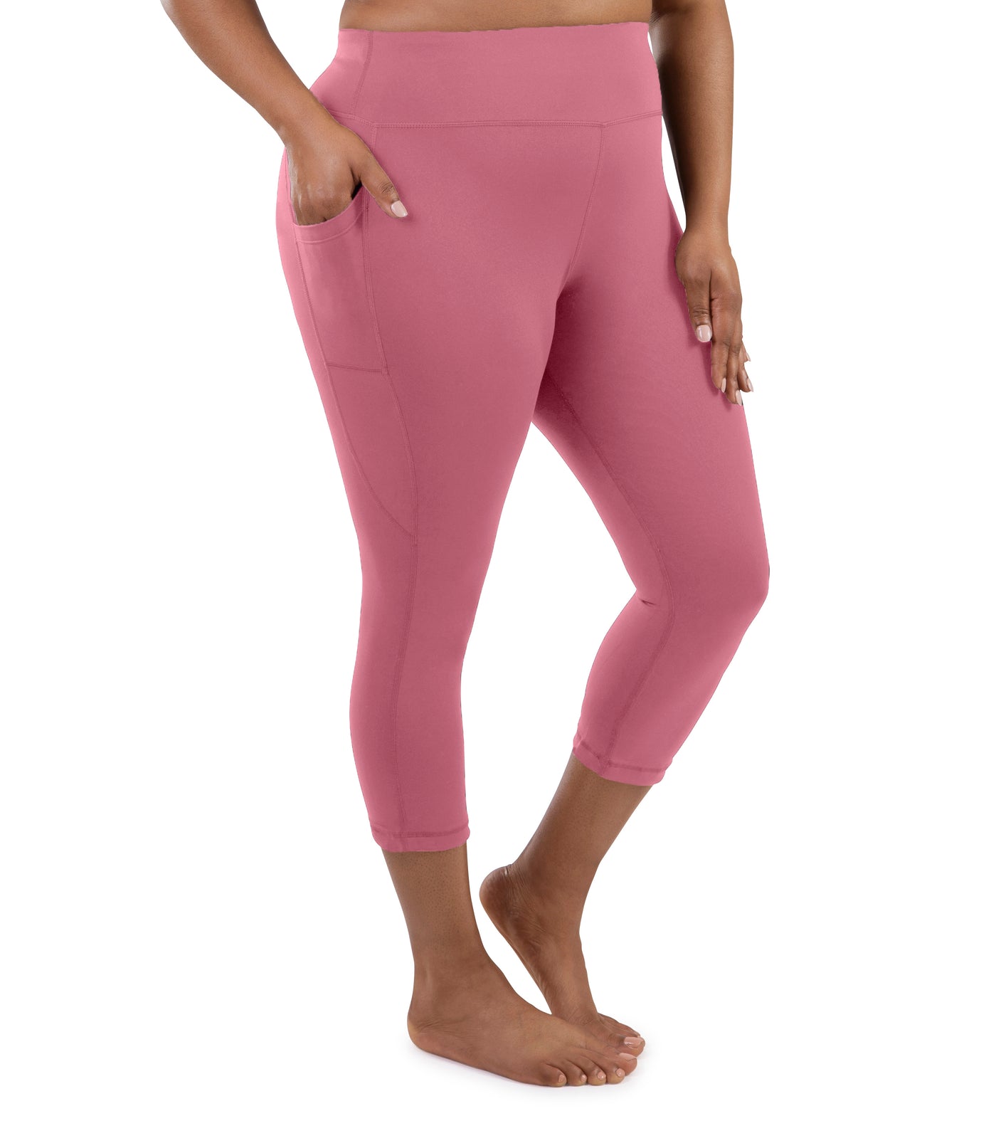 Bottom half of plus sized woman, facing front, wearing JunoActive JunoStretch Side Pocket Capris in warm mauve. The hem falls a few inches above ankle and have pockets on both sides.