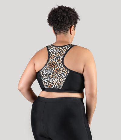 Plus size woman, facing back, wearing JunoActive's QuikEnergy Zip Front plus size Swim Bra featuring leopard print on center back racer back.