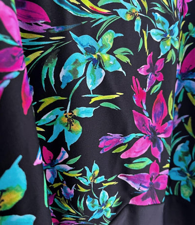 Close up of JunoActive's QuikEnergy Empire Tanksuit in night Lillies print black. 