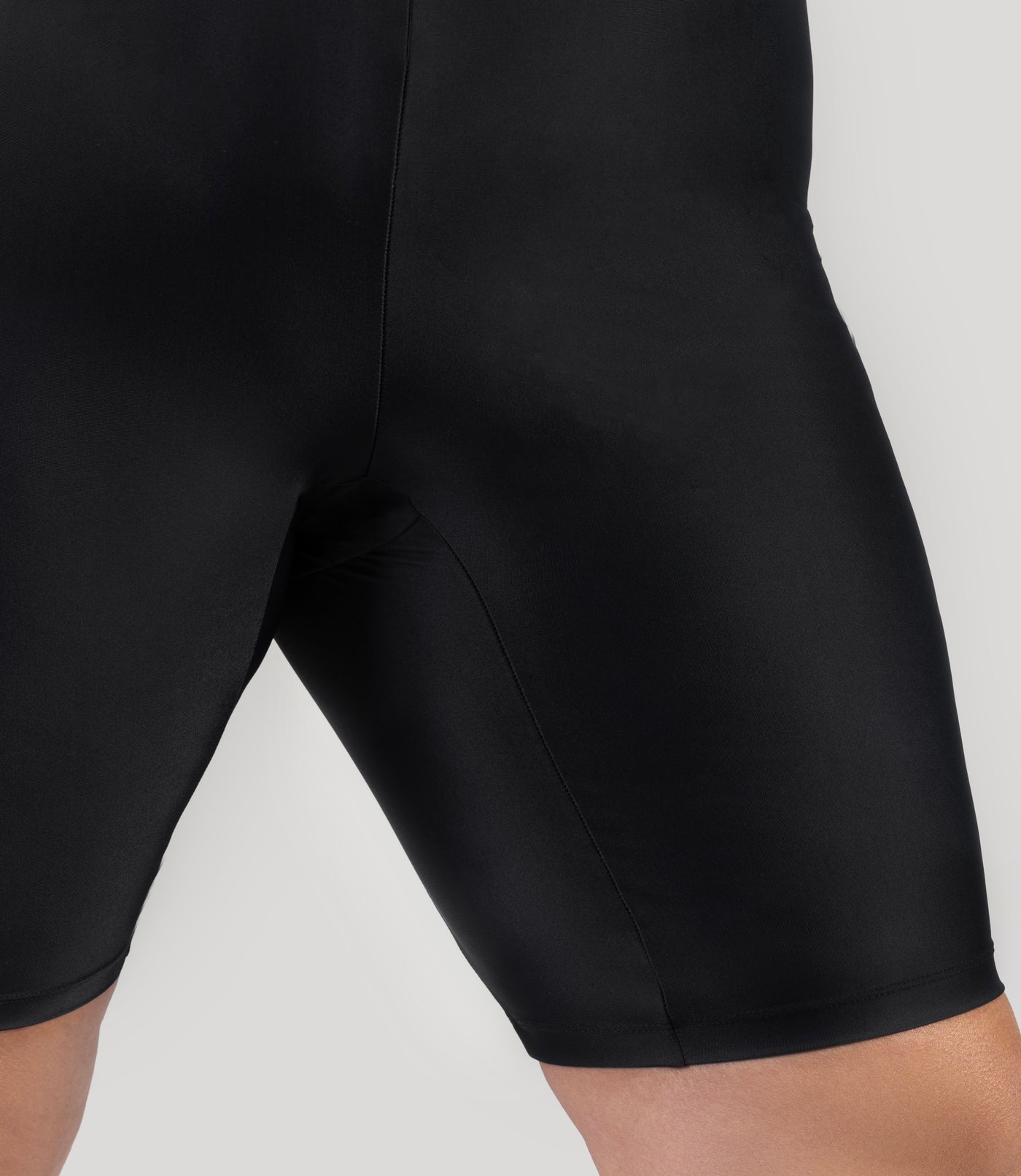 Plus size model wearing QuikEnergy plus size swim short, close-up, featuring updated gusset for superior comfort and fit. Plus size swim bike shorts and fall a couple inches above the knee.