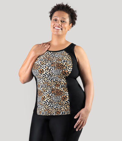 Plus size model, facing front, wearing JunoActive's QuikEnergy Tankini Swim Top. Right hand on right shoulder.