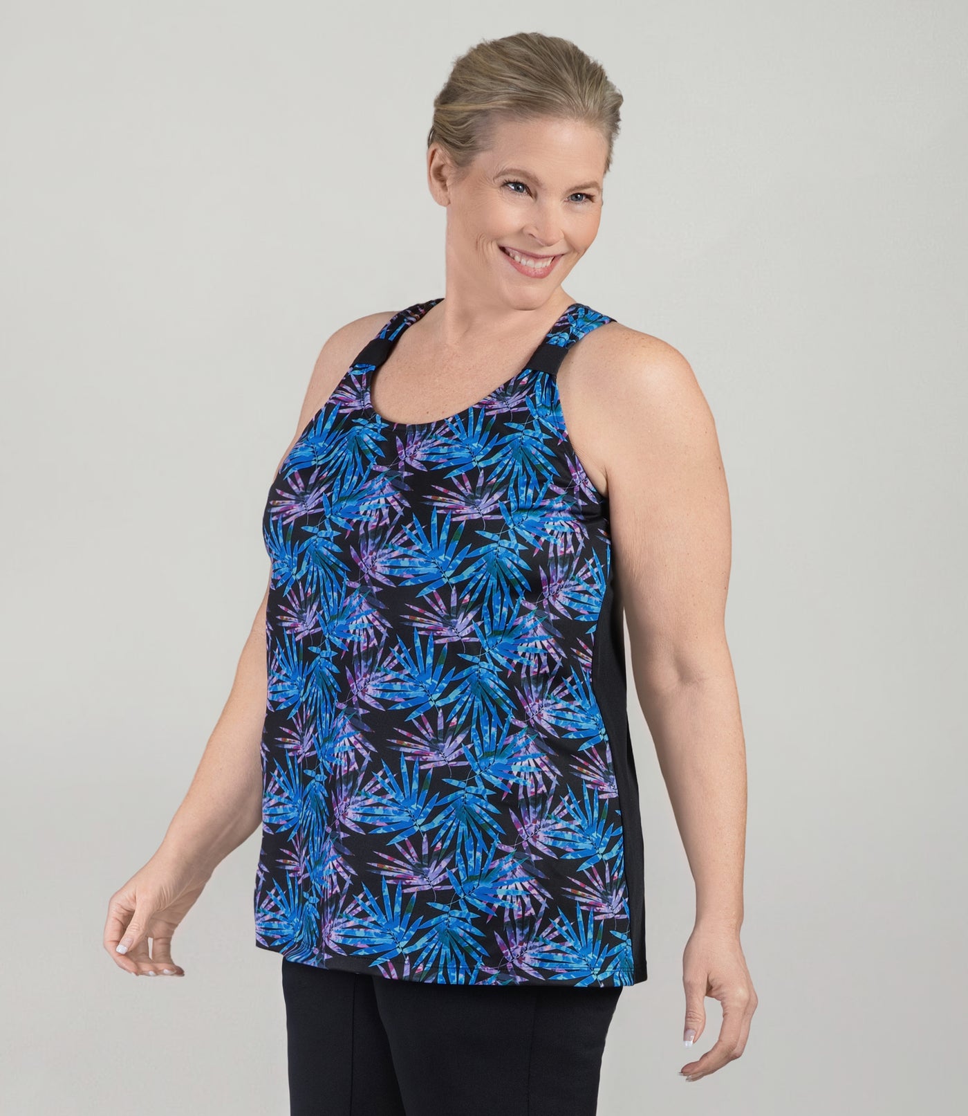 Plus size model, facing front, wearing AquaSport Hanalei Plus size Tankini Top Jewel Palmetto Print.