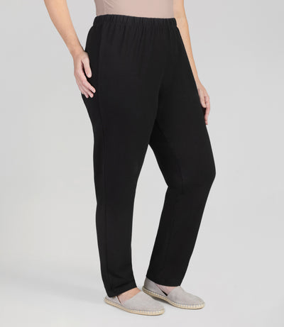 Front view, bottom half of plus sized woman, wearing JunoActives Ultraknit Loose Fit Leggings, full length, in black.