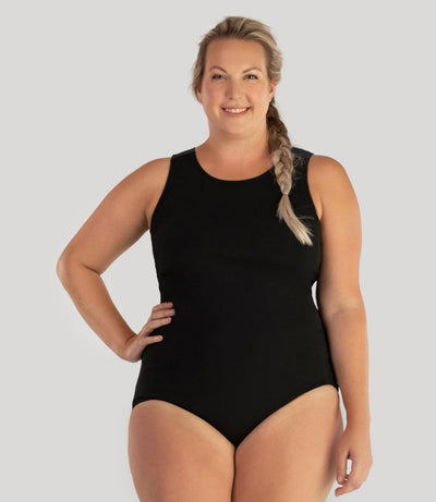 Plus size model, facing front, wearing JunoActive's Aquasport Crossback plus size Tanksuit in color black.