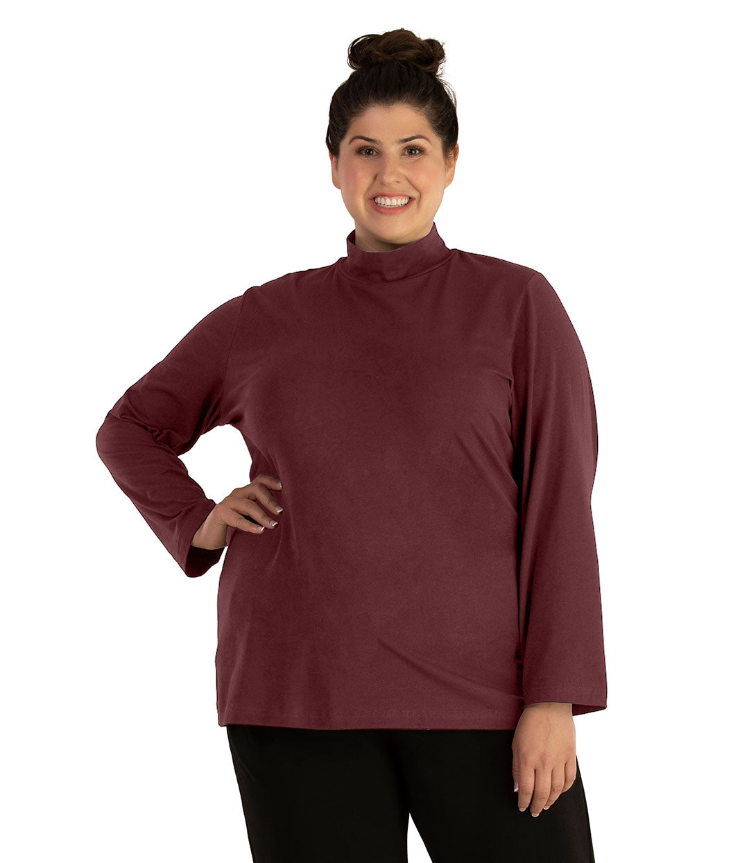 Plus size woman, facing front looking left, wearing JunoActive plus size Stretch Naturals Lite Mock Neck Top in the color Chestnut. She is wearing JunoActive Plus Size Leggings in the color Black.