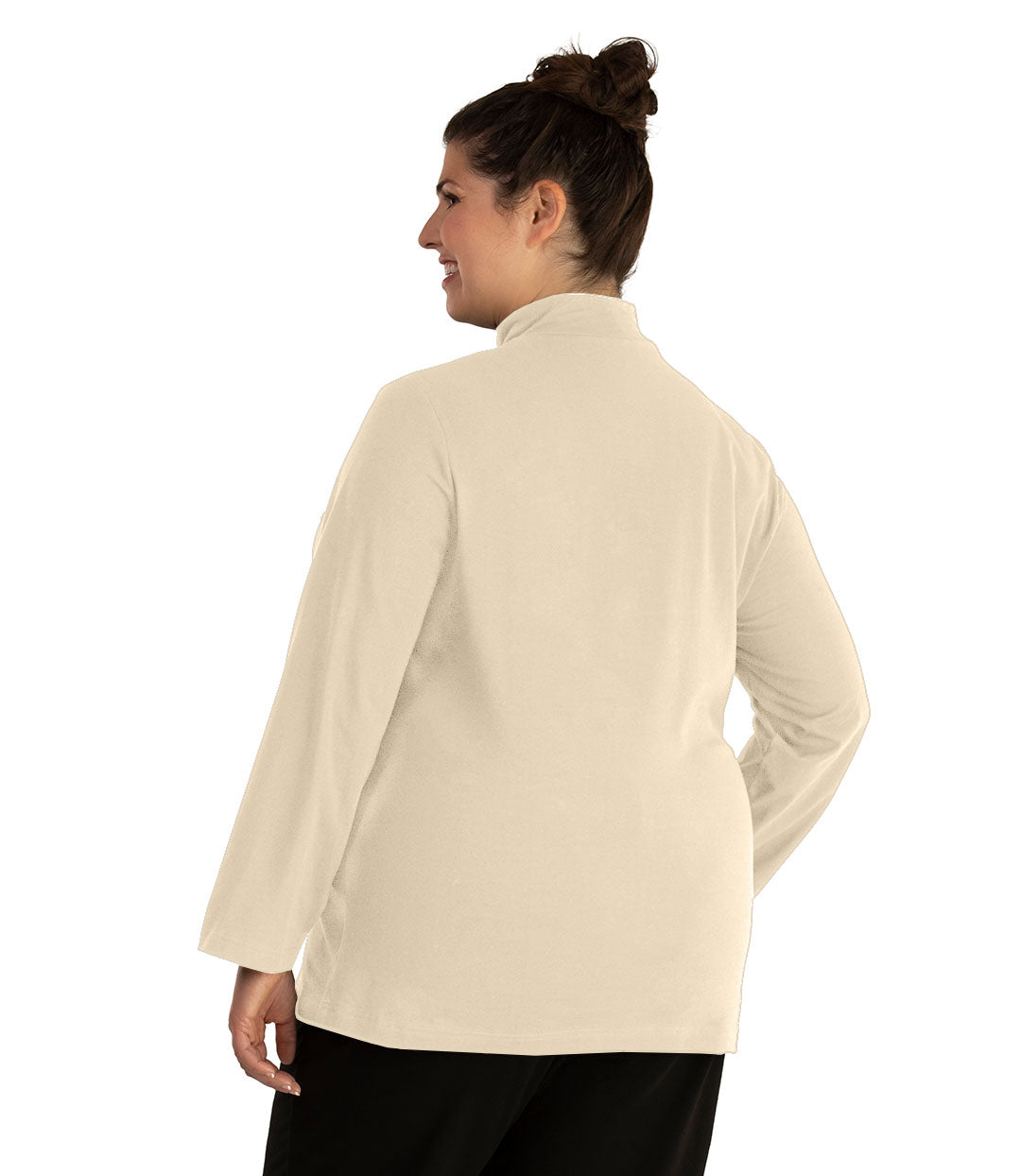 Plus size woman, facing back looking left, wearing JunoActive plus size Stretch Naturals Lite Mock Neck Top in the color Cream. She is wearing JunoActive Plus Size Leggings in the color Black.