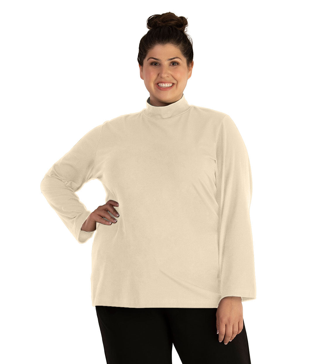 Plus size woman, facing front looking left, wearing JunoActive plus size Stretch Naturals Lite Mock Neck Top in the color Cream. She is wearing JunoActive Plus Size Leggings in the color Black.